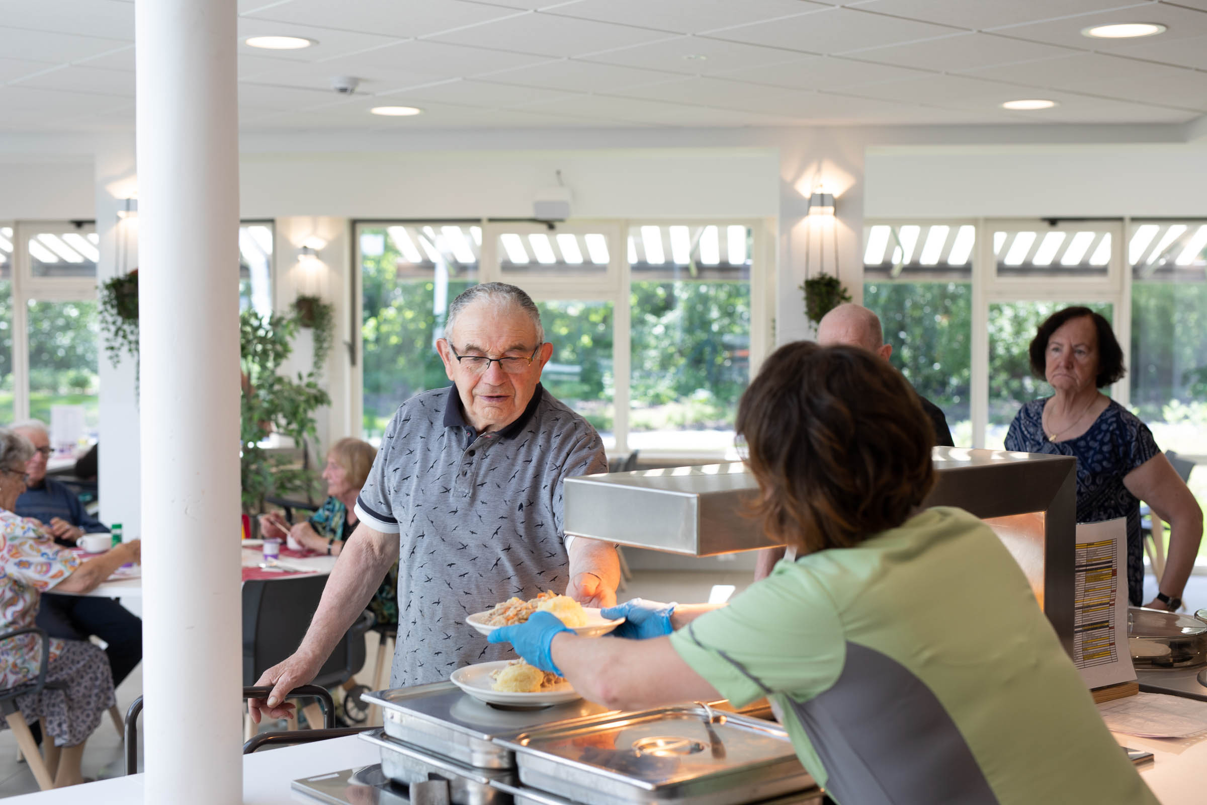 Seniorenzorg Philippus Neri bediening aan de toog van het buffet van 't Molenhof in Sint-Pauwels